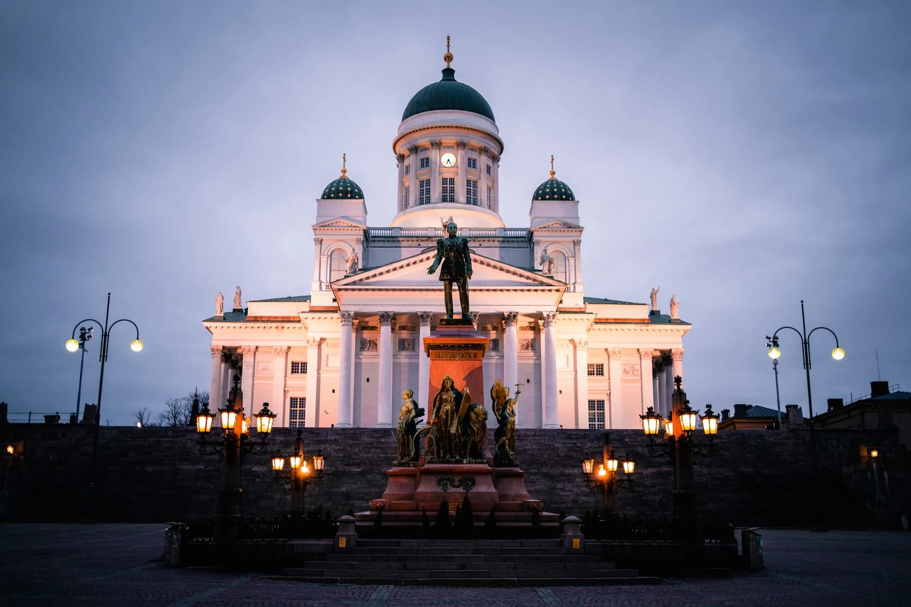 Helsinki Cathedral and the Alexander II statue illuminated at dusk