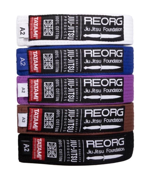 White, blue, purple, brown, and black BJJ belts stacked in a Tatami Fightwear product photograph.