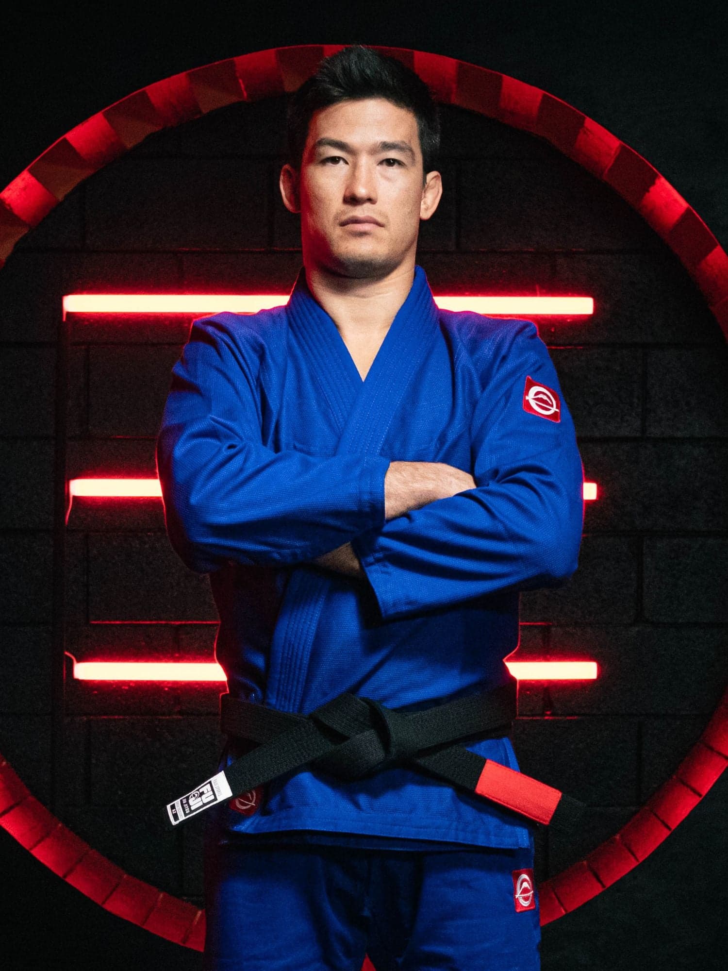 A model wearing a blue FUJI gi in a product photograph.