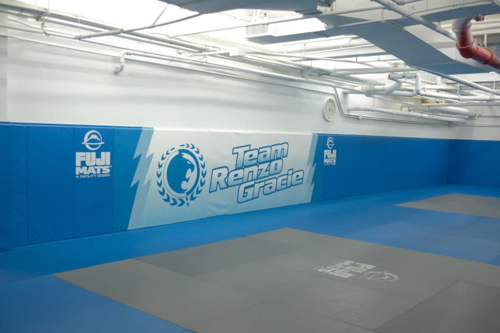 Blue-and-gray mats inside Renzo Gracie Academy.
