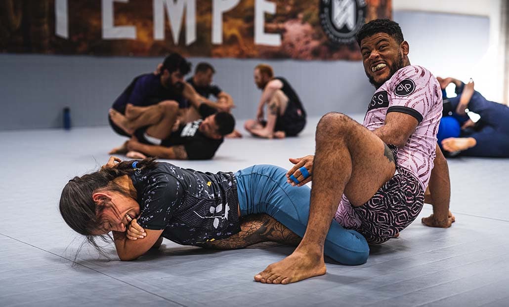 Two grapplers smiling during a no-gi training round.