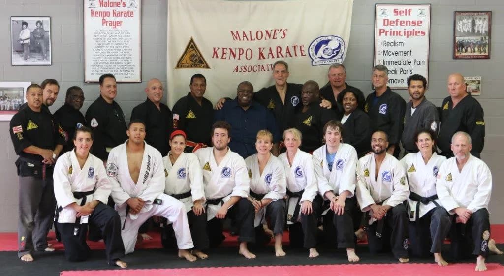 Group photo of Malone's Kenpo Karate and Clinch Jiu Jitsu MMA & Fitness students and instructors posed on mats in a gym in Port Reading, NJ