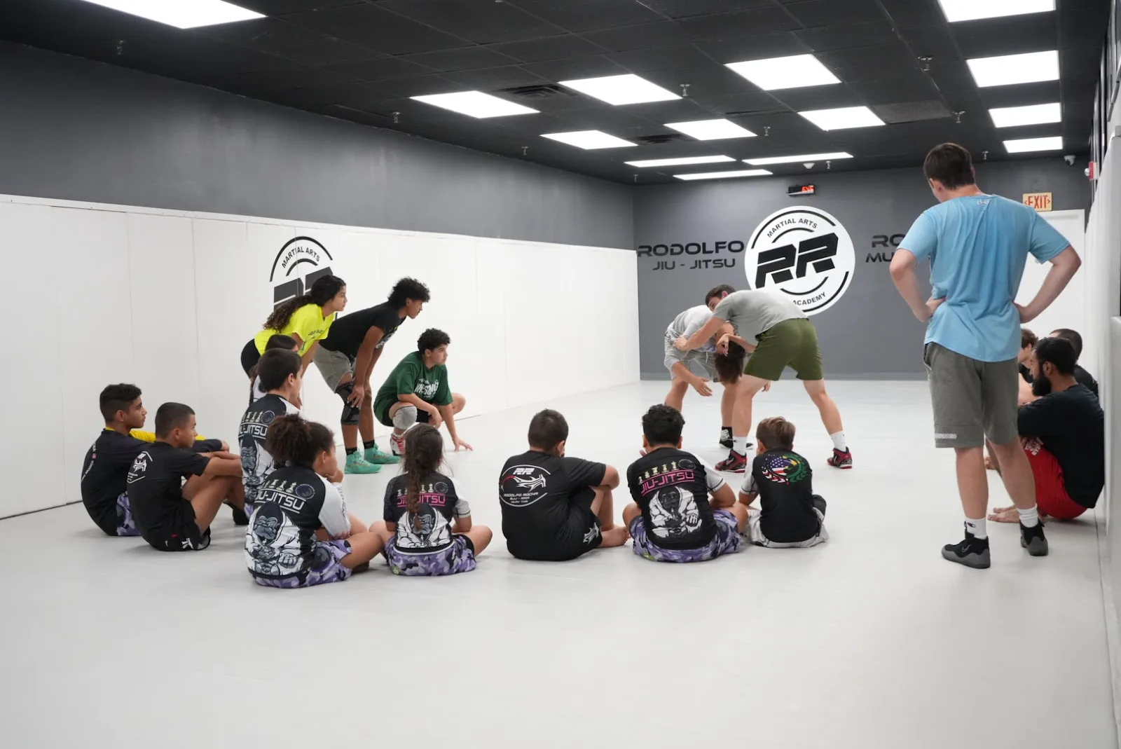 RR Martial Arts Academy in West Long Branch, NJ, featuring a BJJ class with students practicing techniques on the mats.